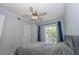 Comfortable bedroom featuring a ceiling fan, closet, and sliding glass doors leading to the outside at 139 Oyster Bay Cir # 200, Altamonte Springs, FL 32701