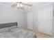 A bedroom has a ceiling fan, two closets, light blue walls, and a bed with a gray headboard at 139 Oyster Bay Cir # 200, Altamonte Springs, FL 32701