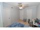 Bedroom with light wood floors, ceiling fan, gray walls, a desk, and two closets at 139 Oyster Bay Cir # 200, Altamonte Springs, FL 32701