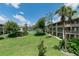 Scenic view of the condo community with large grassy area, mature trees, and tennis court in the background at 139 Oyster Bay Cir # 200, Altamonte Springs, FL 32701