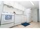 Compact kitchen with white appliances, tile floors, and ample cabinet space, perfect for cooking needs at 139 Oyster Bay Cir # 200, Altamonte Springs, FL 32701