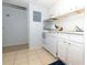 Efficient kitchen with white cabinets, appliances, and tile floors, offering a clean and functional space at 139 Oyster Bay Cir # 200, Altamonte Springs, FL 32701