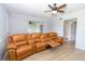 Inviting living room featuring wood-look floors, ceiling fan, and plush leather sofa with cup holders at 139 Oyster Bay Cir # 200, Altamonte Springs, FL 32701
