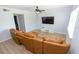 Comfortable living room with wood-look floors, ceiling fan, TV, and leather sofa, great for relaxation at 139 Oyster Bay Cir # 200, Altamonte Springs, FL 32701