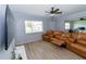 Relaxing living room with wood-look floors, ceiling fan, and large leather sofa, perfect for entertaining at 139 Oyster Bay Cir # 200, Altamonte Springs, FL 32701