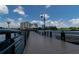 Scenic view of a community pier extending over the water, with buildings and a water tower in the background at 139 Oyster Bay Cir # 200, Altamonte Springs, FL 32701