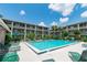 Community pool with lounge chairs, mature palms and lush green landscaping surrounding multi-story buildings at 139 Oyster Bay Cir # 200, Altamonte Springs, FL 32701