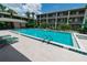 Sparkling community pool with plenty of lounge chairs and lush landscaping, near multi-story buildings at 139 Oyster Bay Cir # 200, Altamonte Springs, FL 32701
