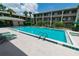 Sparkling community pool with plenty of lounge chairs and lush landscaping, near multi-story buildings at 139 Oyster Bay Cir # 200, Altamonte Springs, FL 32701
