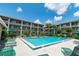 Community pool surrounded by sun loungers, lush landscaping, and multi-story buildings at 139 Oyster Bay Cir # 200, Altamonte Springs, FL 32701
