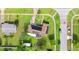 Captivating aerial perspective showcasing a home with solar panels, an extended patio, and lush surrounding greenery at 1566 Providence Blvd, Deltona, FL 32725