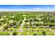 Aerial view showcasing the neighborhood and the tree lined streets on a sunny day at 1566 Providence Blvd, Deltona, FL 32725