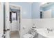 This bathroom features a toilet with decorations and a sink with white cabinets and blue walls at 1566 Providence Blvd, Deltona, FL 32725