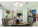 Bright dining room with a glass table set for four, and views of the living room and kitchen at 1566 Providence Blvd, Deltona, FL 32725