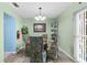 Cozy dining room with wood look floors, seating for four, and a corner display cabinet at 1566 Providence Blvd, Deltona, FL 32725