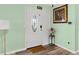 The home's foyer featuring hardwood floors, a glass front door, and fresh light green paint at 1566 Providence Blvd, Deltona, FL 32725