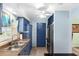 Galley kitchen featuring blue cabinets, stainless steel appliances, and a double sink at 1566 Providence Blvd, Deltona, FL 32725