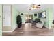 Open-concept living room featuring tile floors, a ceiling fan, and a sliding glass door at 1566 Providence Blvd, Deltona, FL 32725