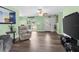The home's living room featuring laminate floors, recessed lighting, and fresh light green paint at 1566 Providence Blvd, Deltona, FL 32725