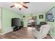 Living room showcasing the hardwood floors, sliding glass doors, and comfortable seating at 1566 Providence Blvd, Deltona, FL 32725