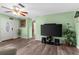 Spacious living room with laminate floors, a ceiling fan, and a front entrance view at 1566 Providence Blvd, Deltona, FL 32725