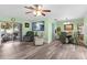 Open-concept living room showcasing the hardwood floors, dining area, and natural light at 1566 Providence Blvd, Deltona, FL 32725