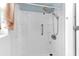 Modern shower equipped with a shower head, handle, and soap holders inside a white tiled stall at 1566 Providence Blvd, Deltona, FL 32725