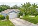 Aerial view of a well-maintained home with a spacious driveway and lush, green lawn at 157 Long Pine Dr, Deltona, FL 32725