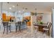 Open-concept kitchen and dining area with wood floors and modern lighting at 157 Long Pine Dr, Deltona, FL 32725