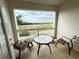 Balcony with outdoor furniture and a picturesque golf course view, perfect for relaxing outdoors at 1592 Heritage Crossing Ct # 202, Reunion, FL 34747