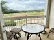 Balcony view overlooking the golf course featuring a table and chairs for outdoor seating at 1592 Heritage Crossing Ct # 202, Reunion, FL 34747