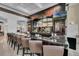 Upscale bar featuring a granite countertop and multiple televisions for an immersive entertainment experience at 1592 Heritage Crossing Ct # 202, Reunion, FL 34747