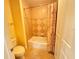 Bathroom with a tiled shower, neutral walls, and tiled floors at 1592 Heritage Crossing Ct # 202, Reunion, FL 34747