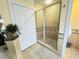 Bathroom with a glass shower stall and decorative tile at 1592 Heritage Crossing Ct # 202, Reunion, FL 34747