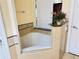 Bathroom featuring a luxurious bathtub with decorative tile and granite countertops at 1592 Heritage Crossing Ct # 202, Reunion, FL 34747