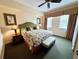 Bedroom with ceiling fan, windows and floral-patterned bedding at 1592 Heritage Crossing Ct # 202, Reunion, FL 34747