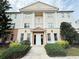 Stylish condo exterior features white columns, well-maintained landscaping, and a welcoming entrance at 1592 Heritage Crossing Ct # 202, Reunion, FL 34747