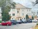Condo exterior showcases ample parking and classic architectural design with columns and coordinated color schemes at 1592 Heritage Crossing Ct # 202, Reunion, FL 34747