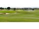 Lush golf course with sand traps, undulating green hills, a lake and well-manicured landscaping at 1592 Heritage Crossing Ct # 202, Reunion, FL 34747
