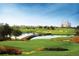 Picturesque golf course view with a bridge over a pond, surrounded by lush landscaping and residences at 1592 Heritage Crossing Ct # 202, Reunion, FL 34747