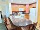 The kitchen features a large breakfast bar, wood cabinets, modern appliances, and stylish countertops at 1592 Heritage Crossing Ct # 202, Reunion, FL 34747