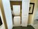Compact laundry area with stacked washer and dryer and access door at 1592 Heritage Crossing Ct # 202, Reunion, FL 34747