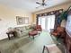 Comfortable living area includes neutral sofa, arm chairs, and sliding doors for natural light and access to lanai at 1592 Heritage Crossing Ct # 202, Reunion, FL 34747