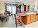 Inviting living area featuring a breakfast bar, elegant furnishings, and sliding doors to the lanai at 1592 Heritage Crossing Ct # 202, Reunion, FL 34747