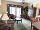 The living room features comfortable seating, elegant decor, and natural light from sliding glass doors at 1592 Heritage Crossing Ct # 202, Reunion, FL 34747