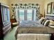 Comfortable main bedroom with a large bed, tropical curtains, and a comfortable chair at 1592 Heritage Crossing Ct # 202, Reunion, FL 34747