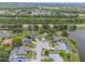 Aerial view showing this home's position on a cul-de-sac near a peaceful pond and surrounding neighborhood at 1631 Woodbay Ct, Kissimmee, FL 34744