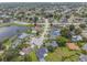 High aerial view of a neighborhood, highlighting the lush landscaping, waterways and proximity to amenities at 1631 Woodbay Ct, Kissimmee, FL 34744