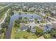 Expansive aerial shot displaying the home's location in a vibrant community near a serene pond at 1631 Woodbay Ct, Kissimmee, FL 34744
