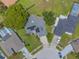 Aerial shot of the home displaying its solar panels and manicured lawn, nestled in a residential area at 1631 Woodbay Ct, Kissimmee, FL 34744
